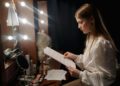 A filmmaker reviews a script at a production desk, representing the creative process behind a co-production treaty.
