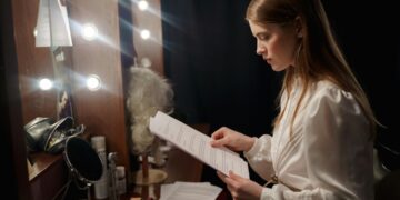 A filmmaker reviews a script at a production desk, representing the creative process behind a co-production treaty.