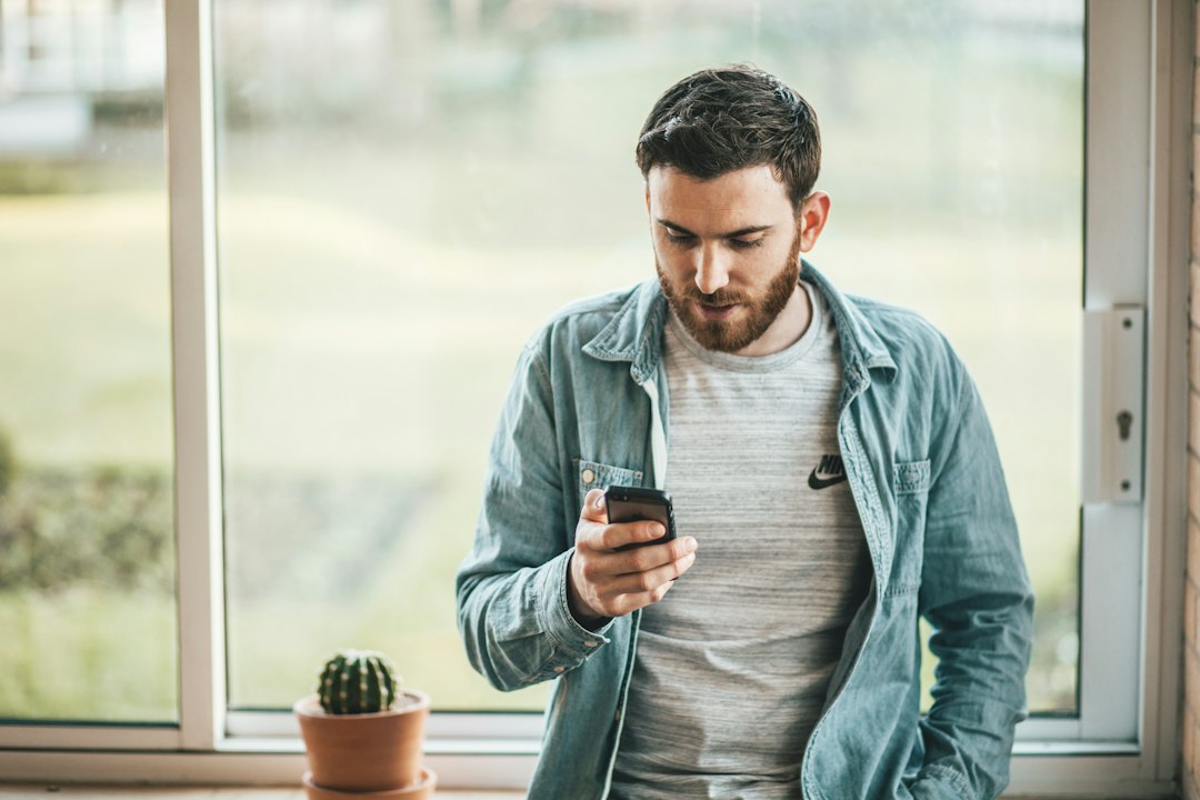 A person checking an energy monitoring app on a smartphone in the morning, tracking household consumption