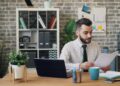 startup-founder-reviewing-documents-office-unsplash - EUwebzine A growth-stage startup founder reviews EU state aid funding documents at her office desk
