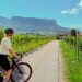 A woman rides one of France's most celebrated cycling routes through golden Loire Valley vineyards during harvest season.