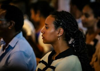 A woman follows the State of Union address on a screen, engaged with the future of European democracy and citizens' rights.