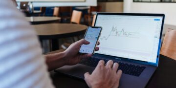 Investor checking STOXX 600 results during earnings season