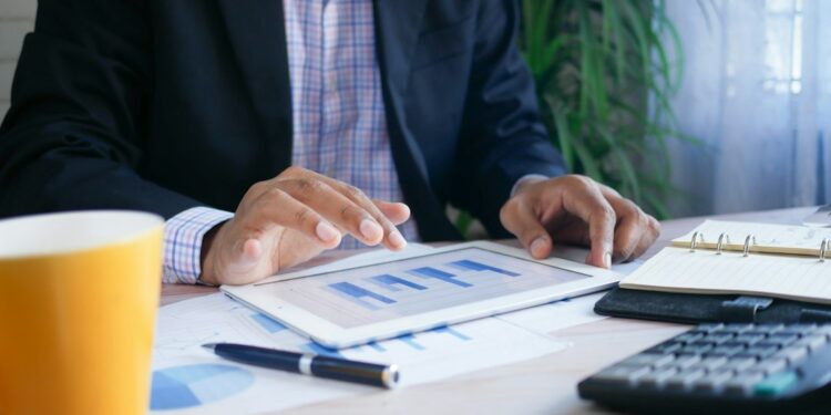Investor reviewing earnings season results on a laptop