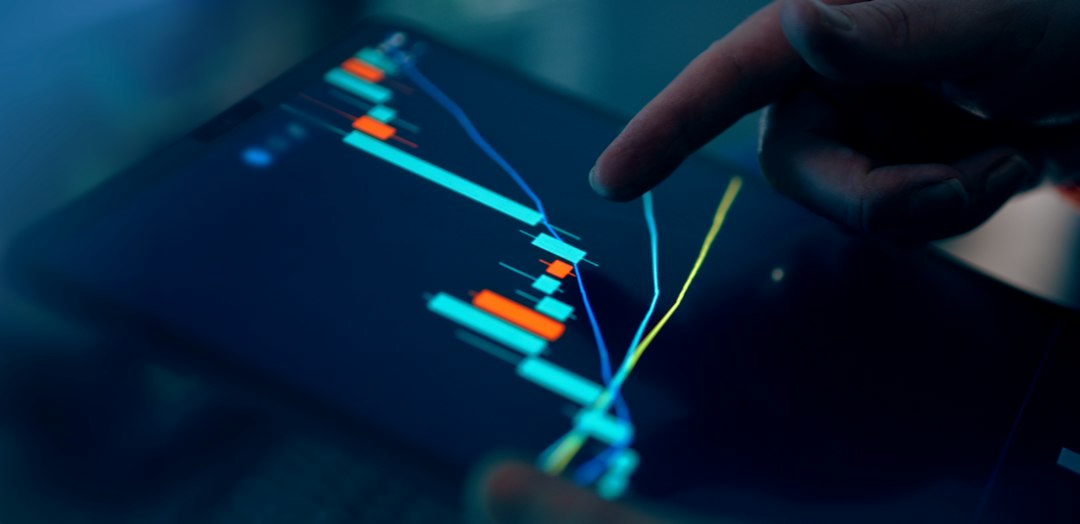 Financial analyst tracking earnings season data on a tablet