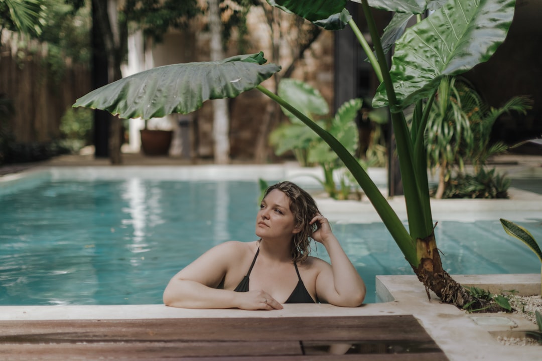 Uma mulher descansa numa piscina mineral privada num dos retiros termais mais exclusivos da Europa, rodeada por terraças de pedra.