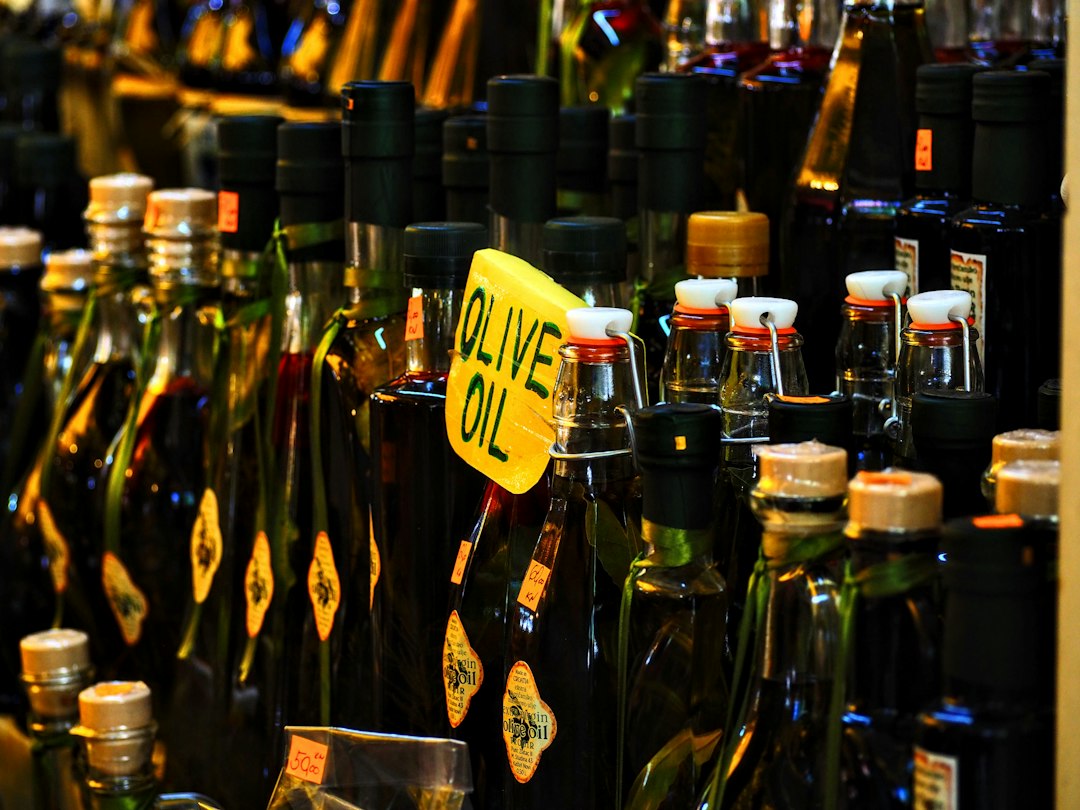 Shopper checking an extra virgin olive oil label in a supermarket aisle